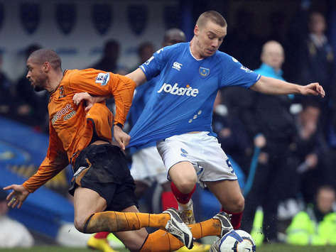 Caleb Folan of Hull City and  Jamie O'Hata of Portsmouth in action during Barclays Premier League match(Getty Images)