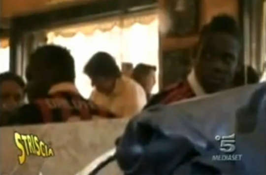 Mario Balotelli wears Milan shirt